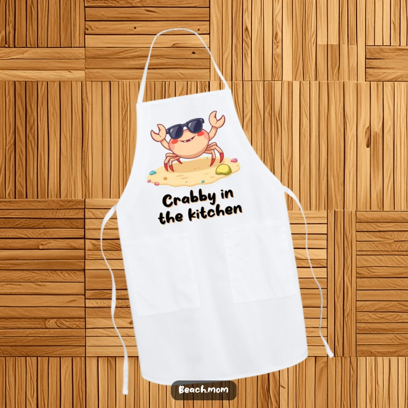 Funny crab apron showing a cheerful crab with sunglasses ready to cook on a colorful beach, for kitchen fun.