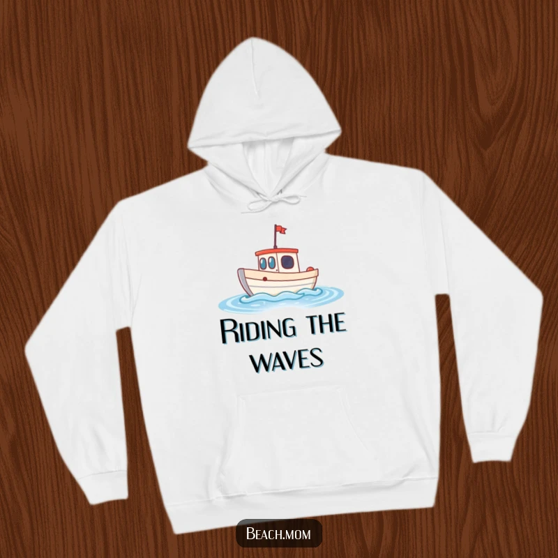 Funny little boat hoodie showcasing a cheerful boat bobbing on sparkling waves, designed for cozy, nautical-inspired comfort.
