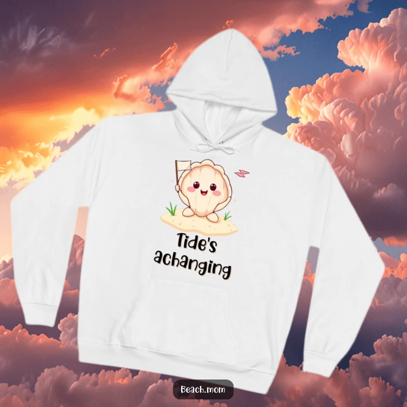 Funny smiling seashell with a tiny flag planted in the sand, depicted on a comfortable hoodie, perfect for cozy beach vibes.