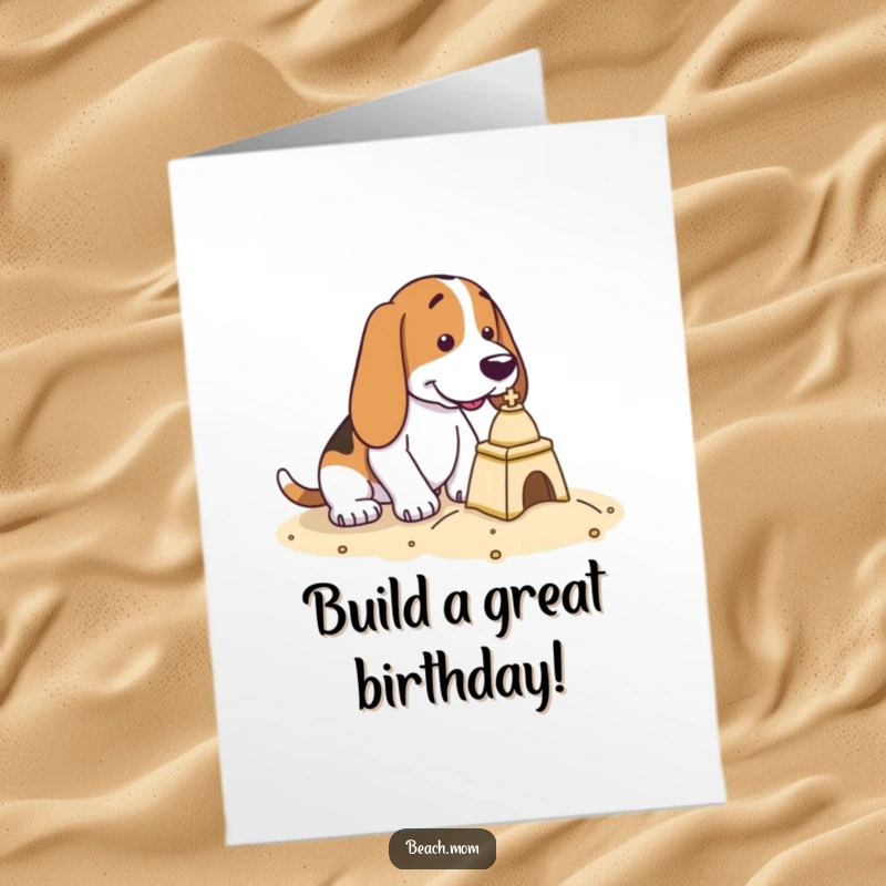 Free Printable Birthday Card: A Basset Hound is intently focused on building a small sandcastle.