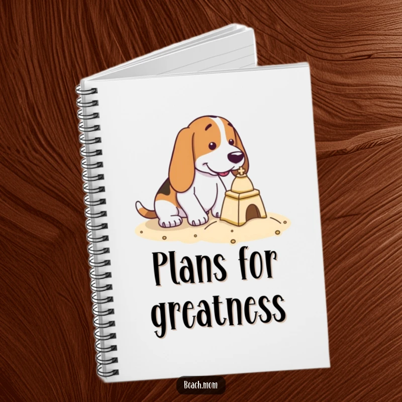 Funny Basset Hound notebook featuring a dog with intense focus, building a tiny sandcastle on its cover.