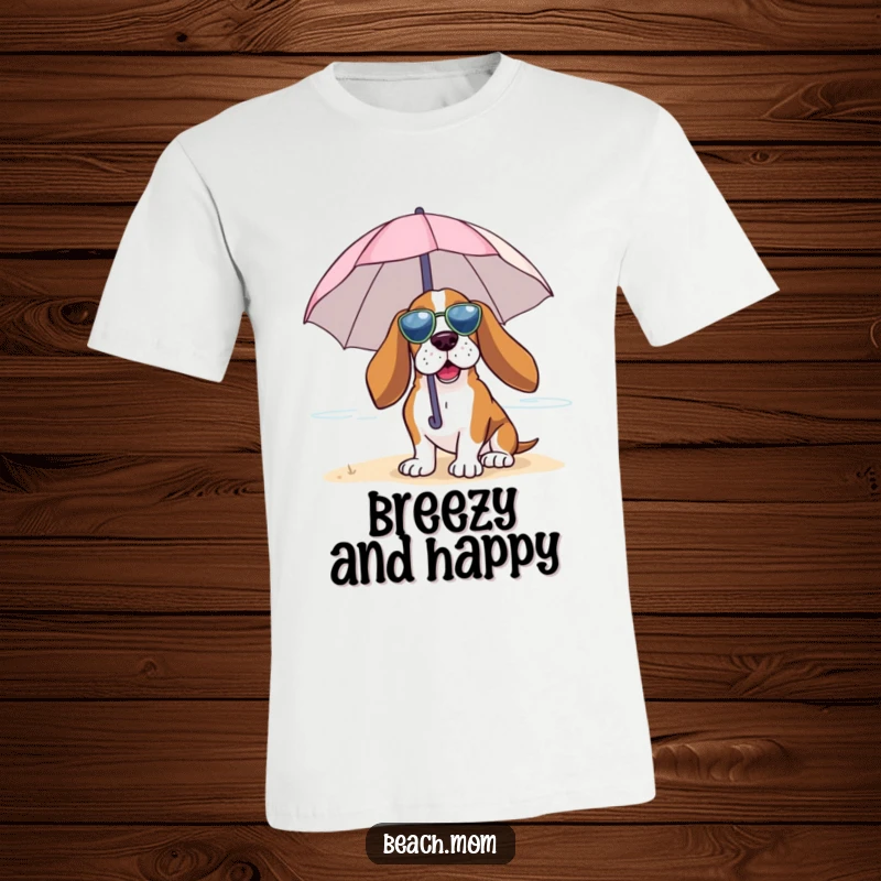 Funny Basset Hound t-shirt showing a dog under a tiny umbrella, joyfully embracing the beach breeze, radiating calm.