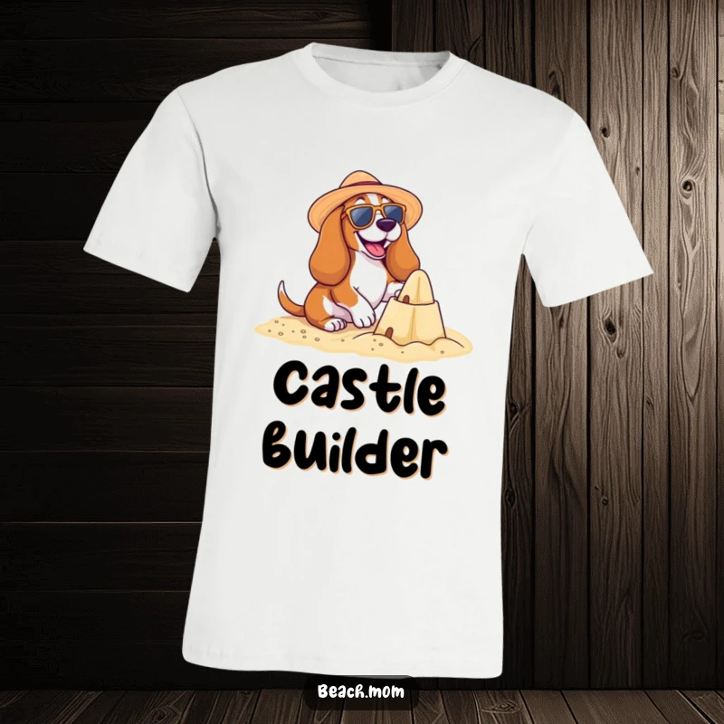 Funny Basset Hound Beach T-Shirt: A happy Basset hound builds a sandcastle, wearing sunglasses and a sun hat, perfect funny gift.